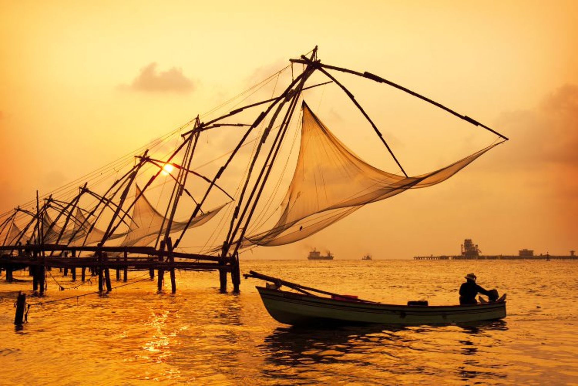 2015-08-sunset-over-chinese-fishing-nets-and-boat-in-cochin-kochi-kerala-india-shutterstock_104171129