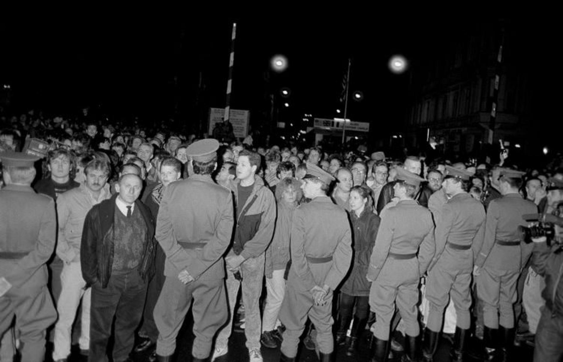 2015-11-east-german-soldiers-act-as-a-barricade-blocking-west-berliners-waiting-to-welcome-east-berlin-citizens-at-the-allied-guardhouse-checkpoint-charlie-november-9-1989