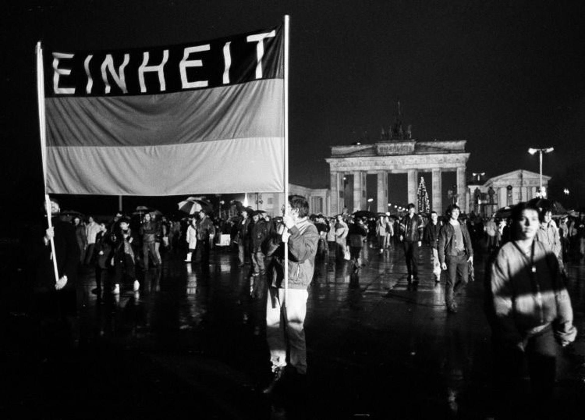 2015-11-this-flag-reading-unity-was-waved-high-as-these-germans-crossed-the-newly-opened-border-december-22