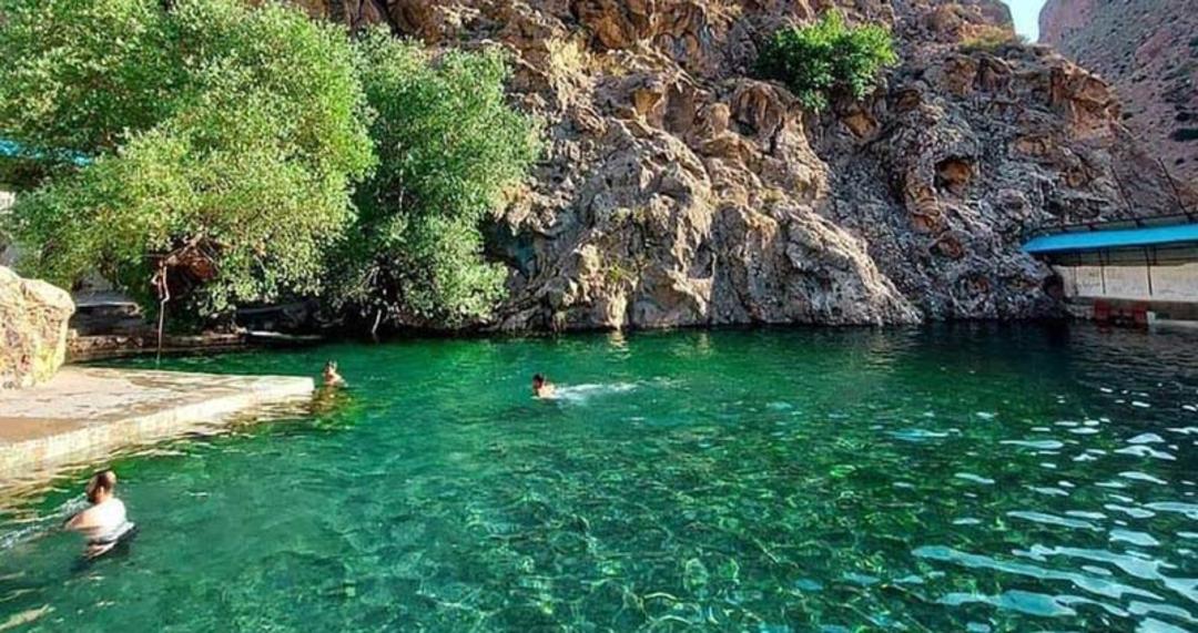 گردشگران در حال شنا در اب زلال چشمه خمده زرین دشت