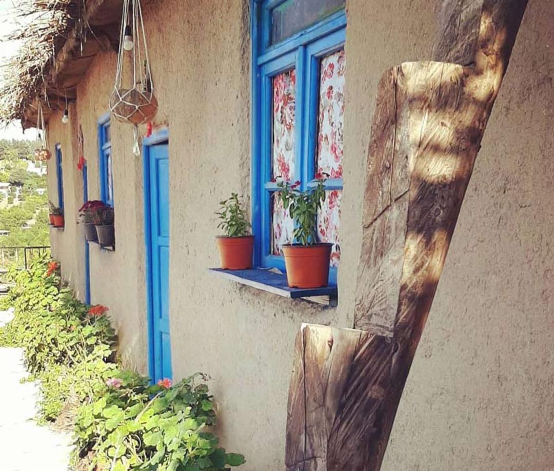 پنجره های آبی روی دیوارهای گلی اقامتگاه بومگردی گالش منزل ساری