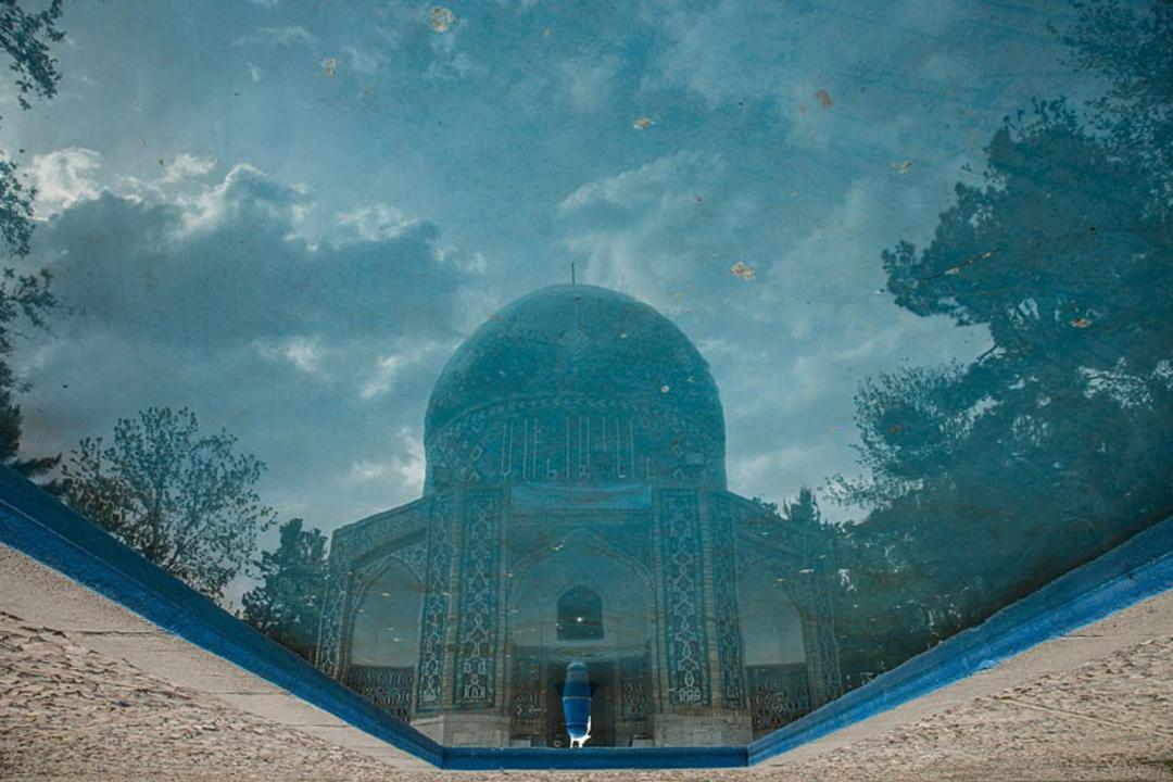 بازتاب تصویر آرامگاه عطار روی آب حوض