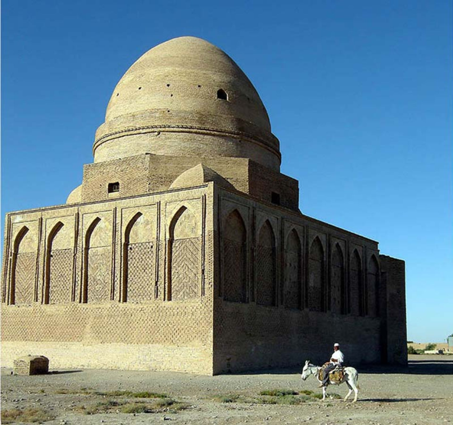مردی کنار آرامگاه بابا لقمان؛ منبع عکس: wikimedia؛ نام عکاس: نامشخص