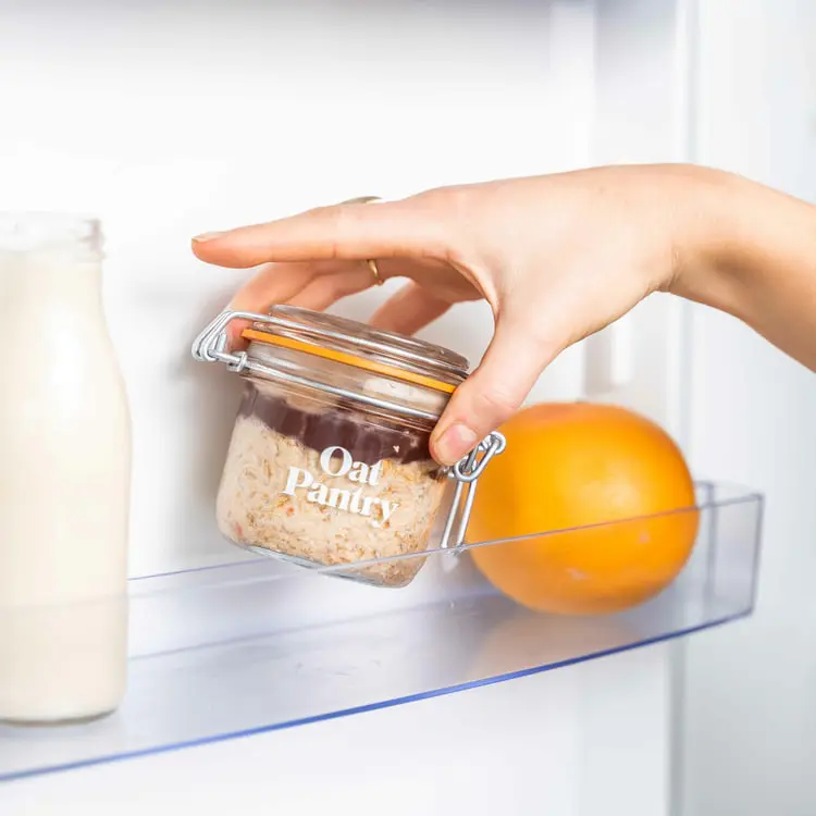 اوتمیل یخچالی (Overnight Oats) در یک ظرف شیشه‌ای کوچک داخل یخچال