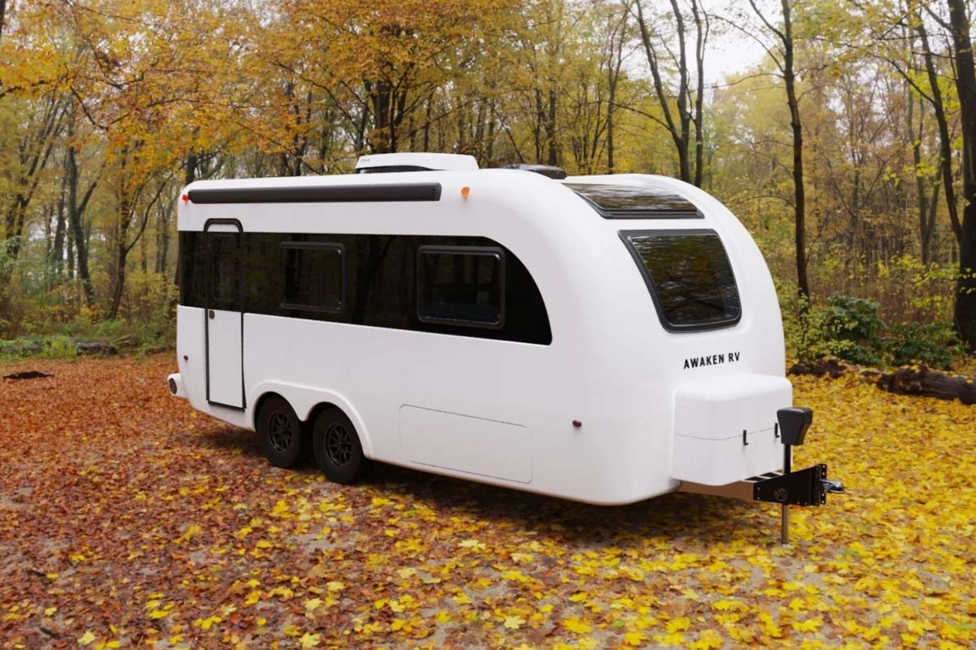 تصویر شاخص کاروان مسافرتی مدرن با برند Awaken RV در میان درختان پاییزی