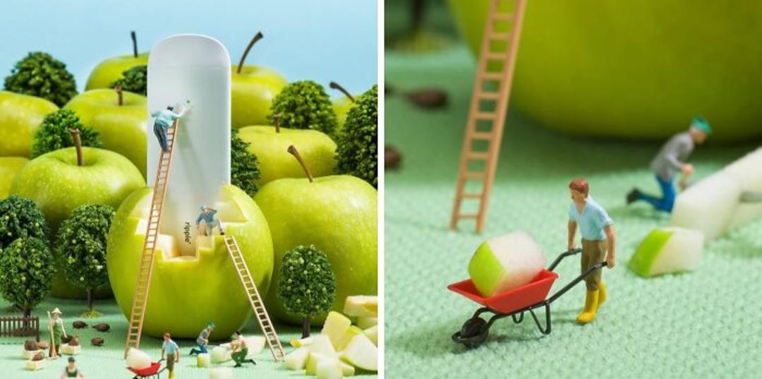 آدمک‌های کوچک در حال کار روی سیب‌های سبز و میوه‌ها