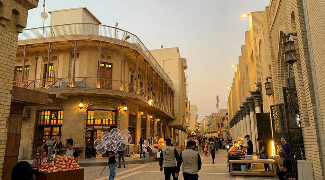 کوچه قدیمی با ساختمان‌های آجری و مغازه‌های سنتی در زمان غروب